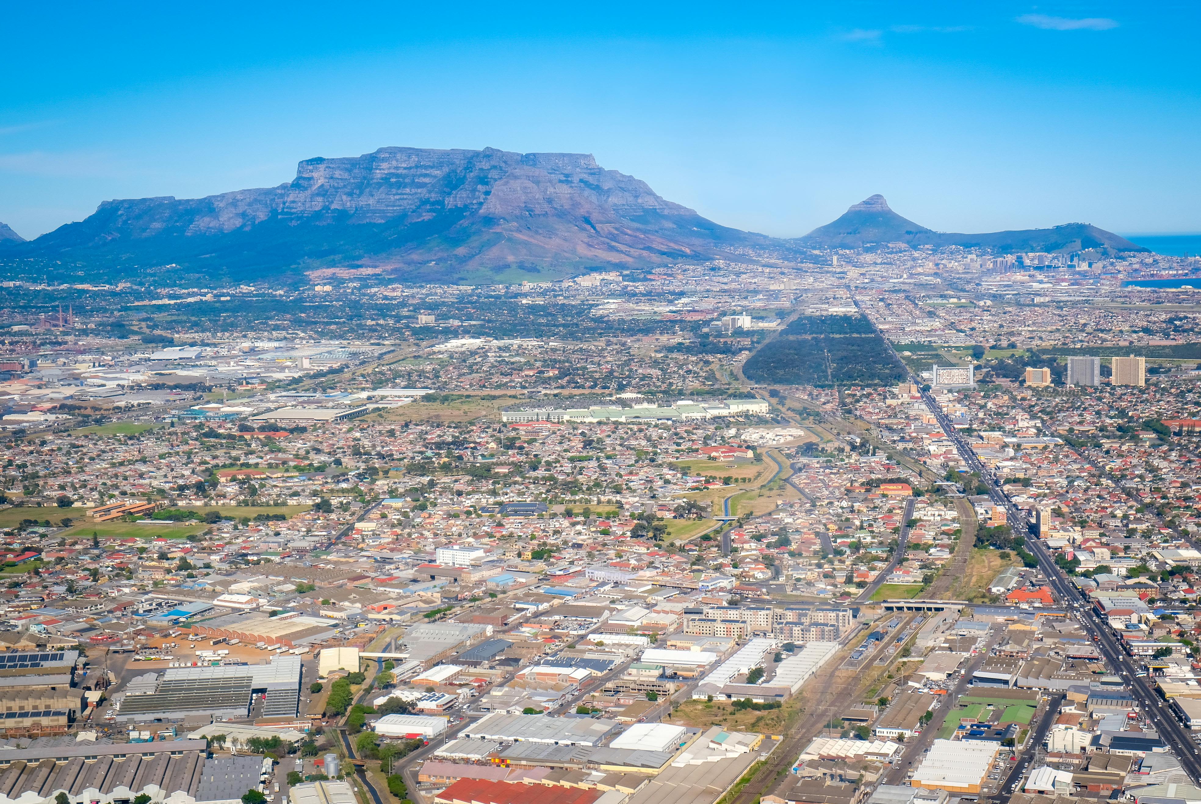 A breathtaking aerial view of Cape Town with Table Mountain in the background on a clear day.
